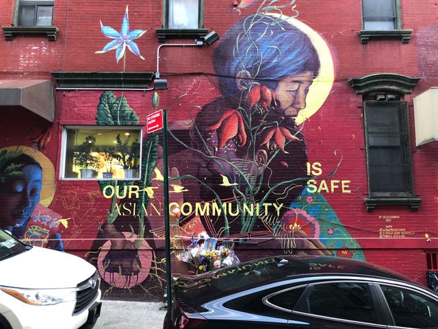 A mural on Mosco Street contains a plea to end anti-Asian hate crime. It also has become a memorial for Christina Yuna Lee, an Asian American woman who was murdered in her nearby apartment.